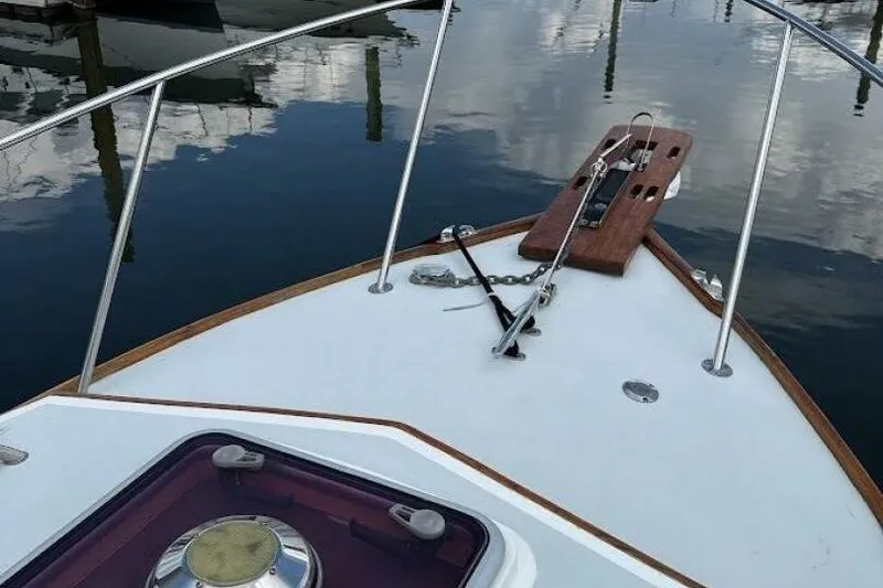 Slide: The Image of Bow of a 2008 Dyer 29 boat with anchor and calm water reflection. - 10