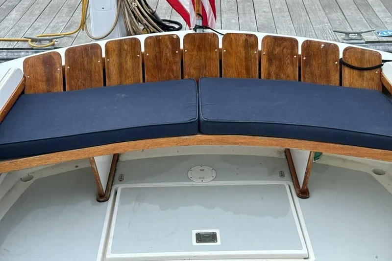 Slide: The Image of Wooden bench with navy cushions on a 2008 Dyer 29 boat deck. - 12