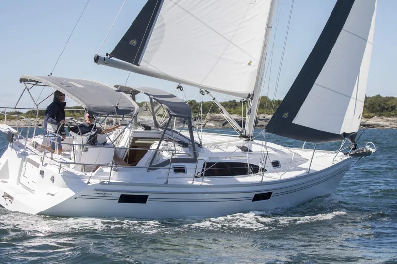 Slide: The Image of 2026 Catalina 316 sailboat cruising on open water with sails unfurled. - 11
