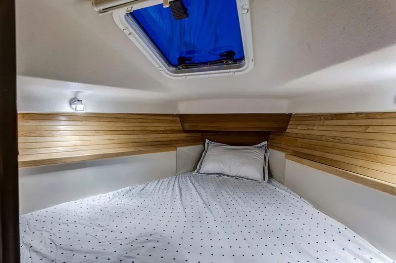 Slide: The Image of Cozy cabin interior of 2026 Catalina 316 sailboat with wood paneling and skylight. - 14