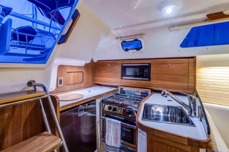 Slide: The Image of Modern kitchen interior of 2026 Catalina 316 yacht with wood finish and stainless steel appliances. - 18