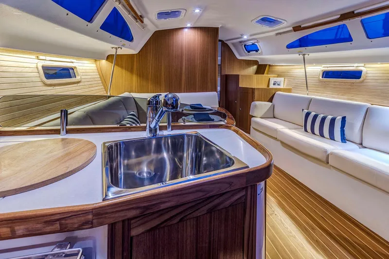 Slide: The Image of Luxurious interior of 2026 Catalina 316 yacht with modern kitchen and comfortable seating. - 19