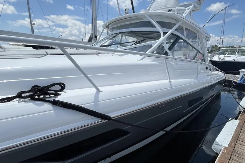 Slide: The Image of 2023 Intrepid 477 Evolution yacht docked, showcasing sleek design and modern features. - 11