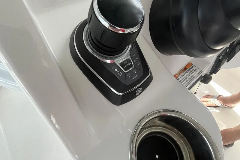 Slide: The Image of 2023 Intrepid 477 Evolution boat control panel with joystick and cup holder. - 17