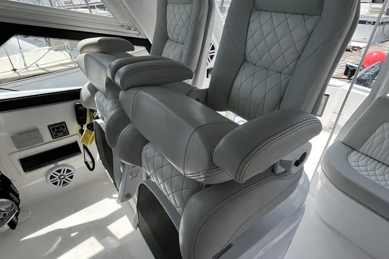 Slide: The Image of Luxurious seating on 2023 Intrepid 477 Evolution boat, featuring quilted upholstery and modern design. - 21