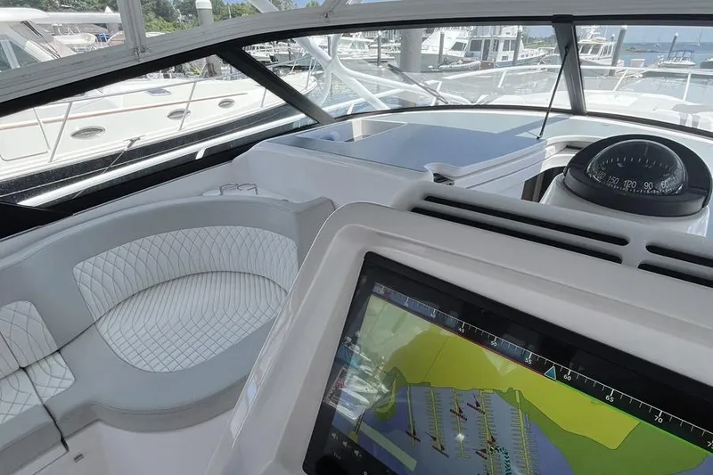 Slide: The Image of 2023 Intrepid 477 Evolution yacht cockpit with navigation display and luxurious seating. - 25
