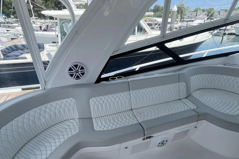 Slide: The Image of Luxurious seating on 2023 Intrepid 477 Evolution yacht, docked at marina. - 27