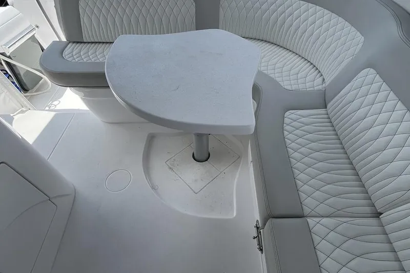 Slide: The Image of 2023 Intrepid 477 Evolution boat interior with elegant seating and table design. - 31