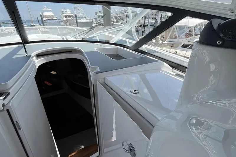 Slide: The Image of 2023 Intrepid 477 Evolution yacht interior with sleek design and marina view. - 34