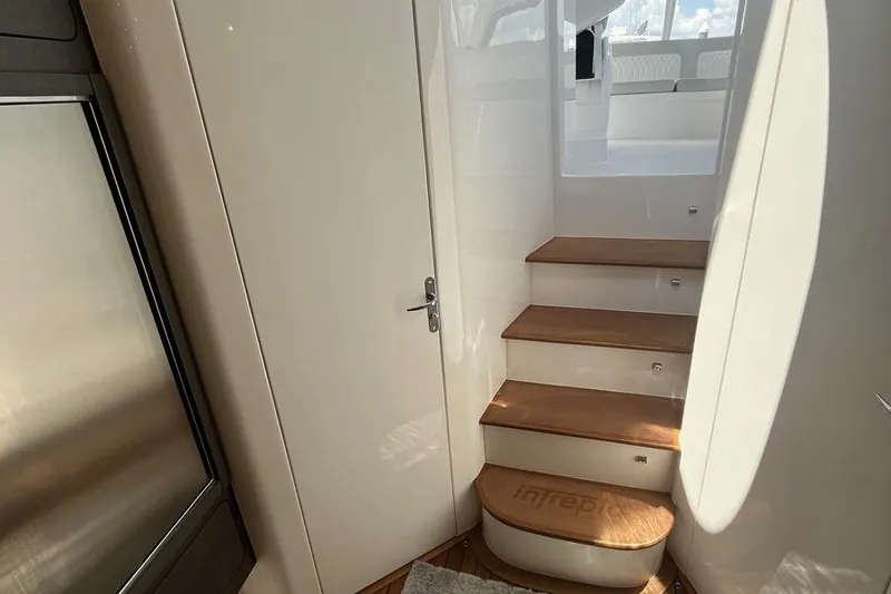 Slide: The Image of Interior stairs of 2023 Intrepid 477 Evolution yacht with wooden steps and sleek design. - 38