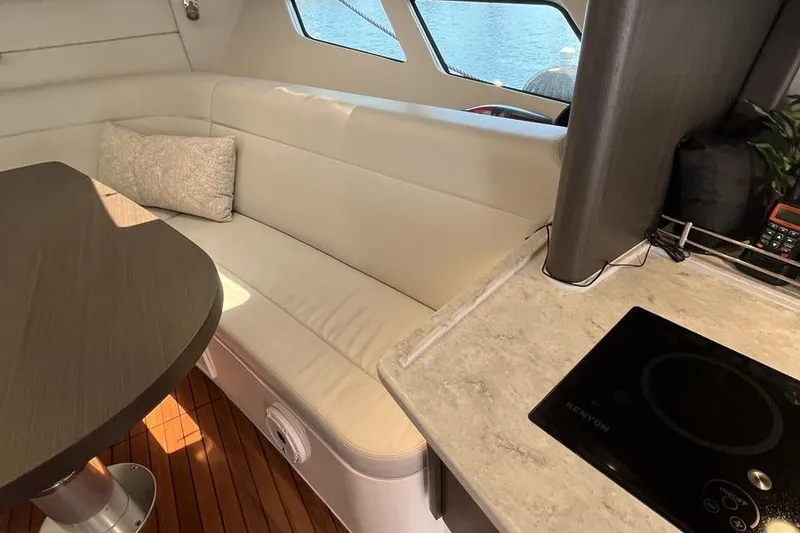 Slide: The Image of Interior of 2023 Intrepid 477 Evolution yacht with modern seating and kitchen area. - 40