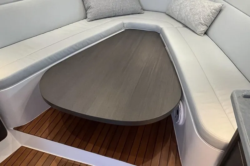 Slide: The Image of 2023 Intrepid 477 Evolution interior with sleek seating and wooden table. - 41