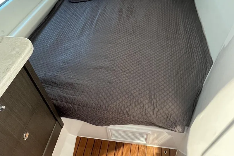 Slide: The Image of 2023 Intrepid 477 Evolution cabin with quilted bedding and wooden flooring. - 42