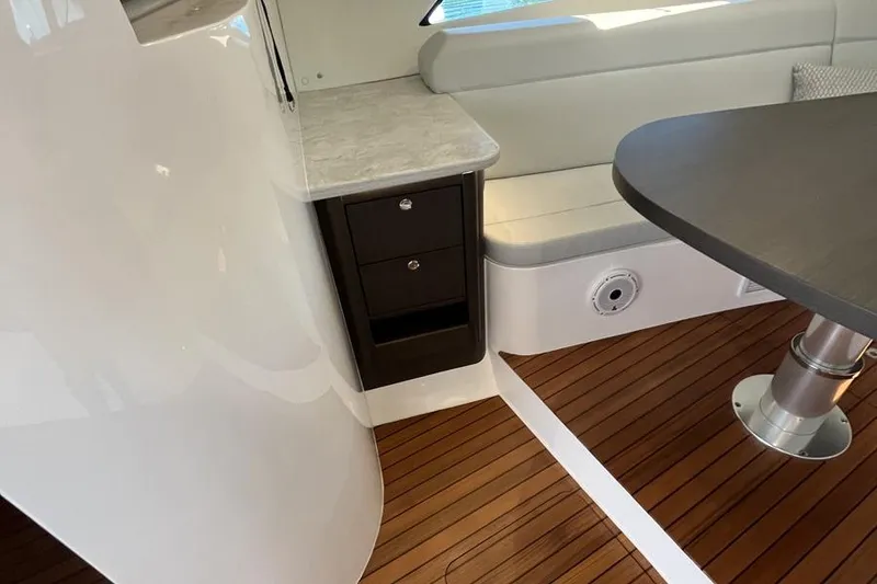 Slide: The Image of Interior of 2023 Intrepid 477 Evolution yacht with wood flooring and modern seating. - 43