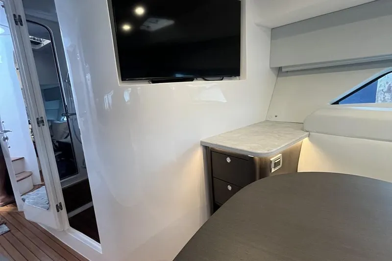 Slide: The Image of Interior of 2023 Intrepid 477 Evolution yacht with TV and modern furnishings. - 44