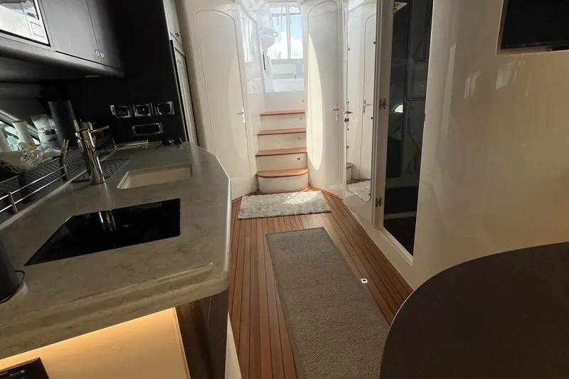 Slide: The Image of Luxurious interior of 2023 Intrepid 477 Evolution yacht with modern kitchen and wooden flooring. - 50