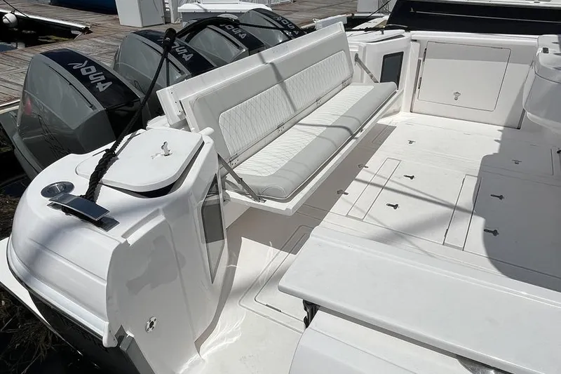Slide: The Image of 2023 Intrepid 477 Evolution boat deck with seating and outboard motors. - 56