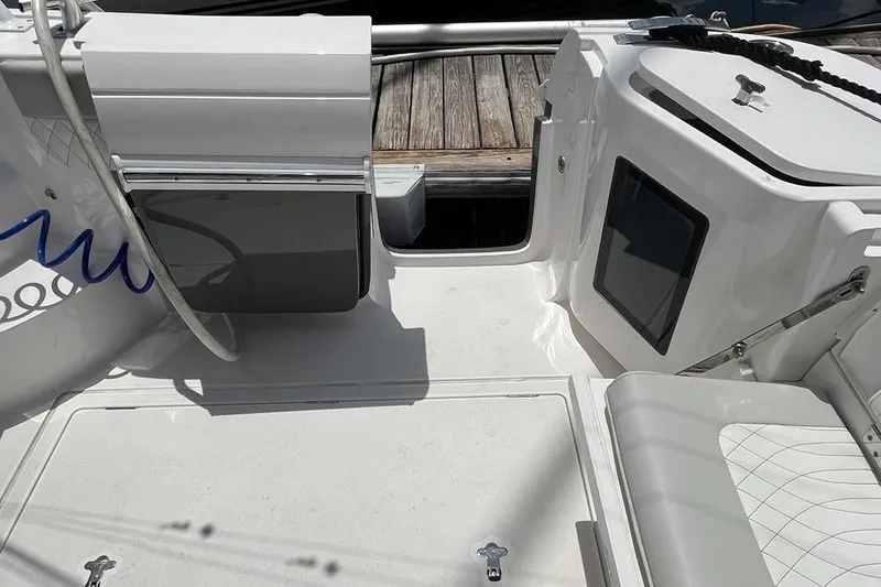 Slide: The Image of 2023 Intrepid 477 Evolution boat deck with seating and storage compartments. - 57