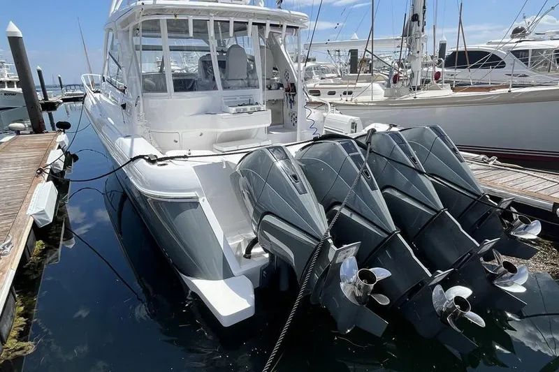 Slide: The Image of 2023 Intrepid 477 Evolution boat docked with powerful outboard engines. - 6