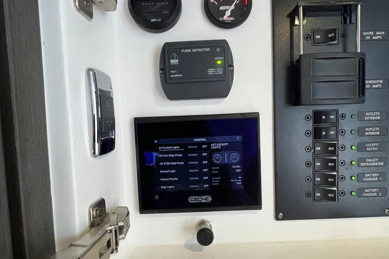Slide: The Image of Control panel of 2023 Intrepid 477 Evolution boat with digital display and switches. - 63