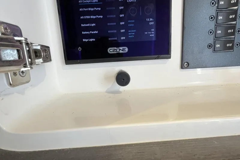 Slide: The Image of Control panel of 2023 Intrepid 477 Evolution boat with digital display and switches. - 64