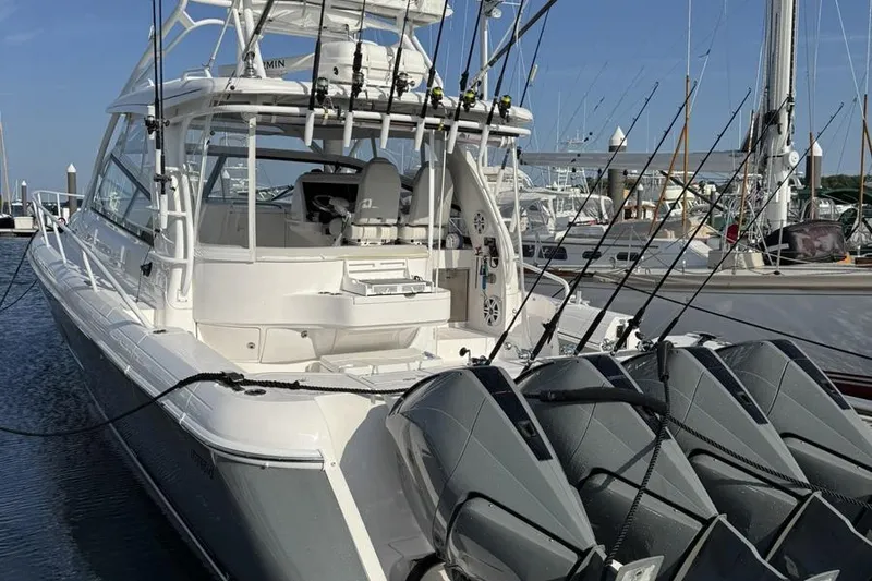 Slide: The Image of 2023 Intrepid 477 Evolution boat with multiple outboard engines docked at marina. - 7