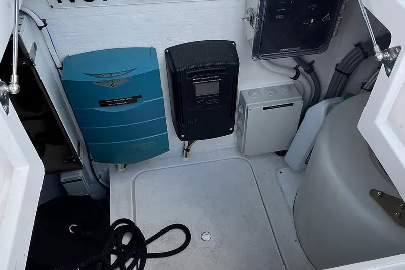 Slide: The Image of 2023 Intrepid 477 Evolution boat electrical compartment with equipment and wiring. - 70