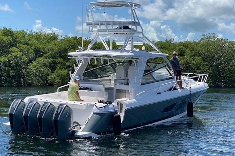 Slide: The Image of 2023 Intrepid 477 Evolution boat with multiple outboard engines on a sunny day. - 74