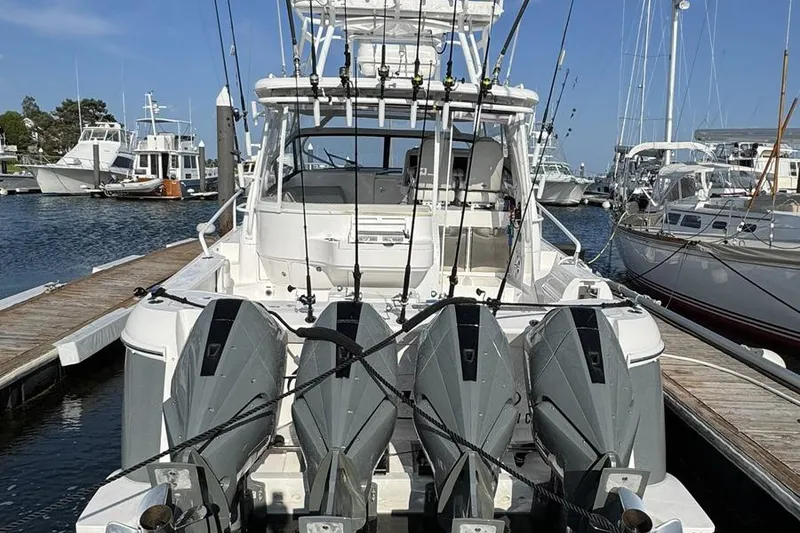 Slide: The Image of 2023 Intrepid 477 Evolution boat with multiple outboard engines docked at a marina. - 8