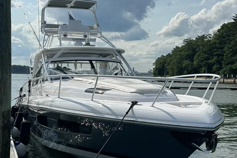 Slide: The Image of 2023 Intrepid 477 Evolution yacht docked, featuring sleek design and advanced navigation equipment. - 9