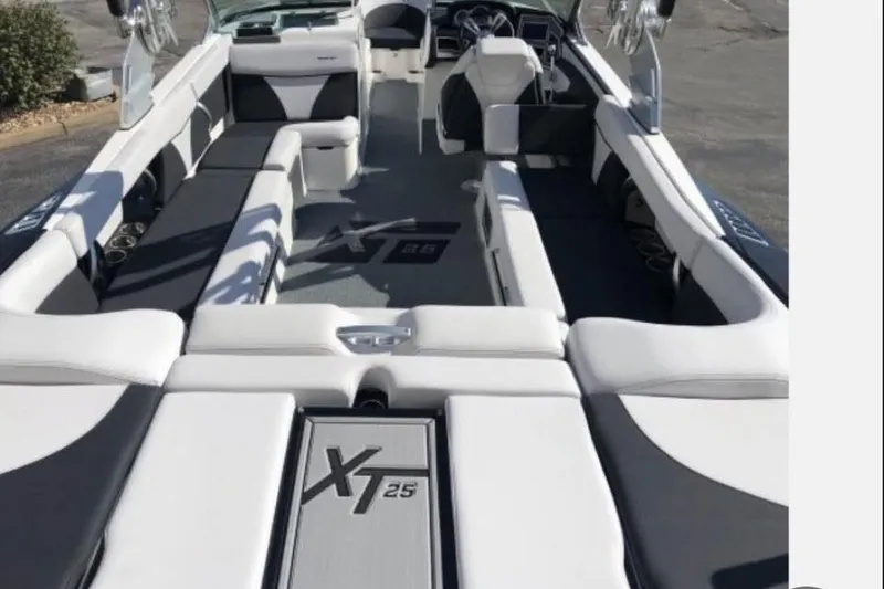 Slide: The Image of 2019 MasterCraft XT25 boat interior with sleek seating and modern design. - 11