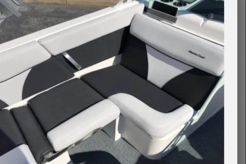 Slide: The Image of 2019 MasterCraft XT25 boat interior seating with black and white upholstery. - 15