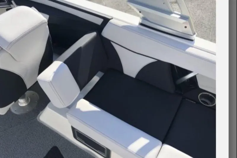 Slide: The Image of 2019 MasterCraft XT25 boat interior with white and black seating. - 17