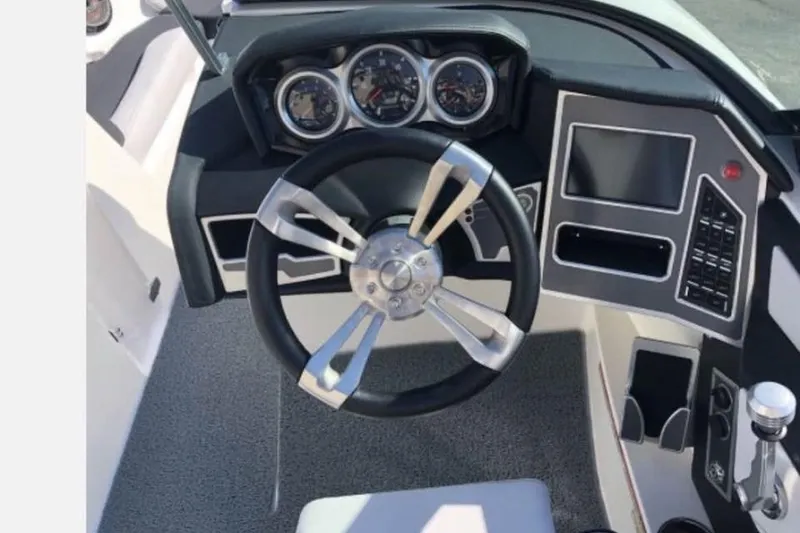 Slide: The Image of 2019 MasterCraft XT25 boat dashboard with steering wheel and control panel. - 6