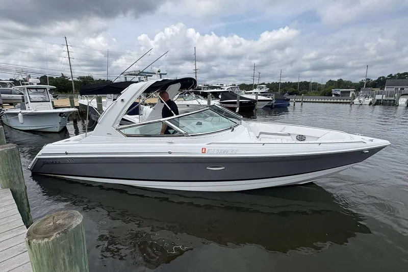 The Image of 2004 Formula 2800 BR boat docked in a marina under cloudy skies. - 1