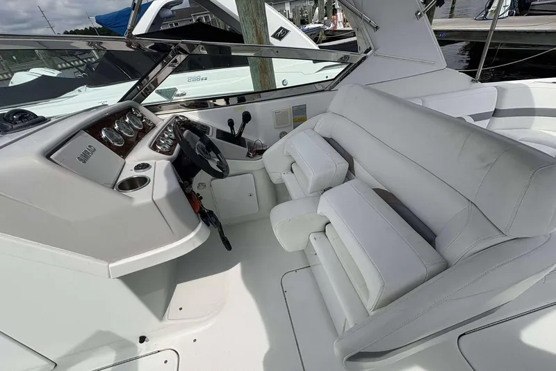 Slide: The Image of 2004 Formula 2800 BR boat interior with white seating and control panel. - 14