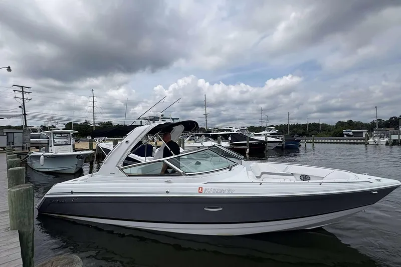Slide: The Image of 2004 Formula 2800 BR boat docked at marina under cloudy sky. - 2