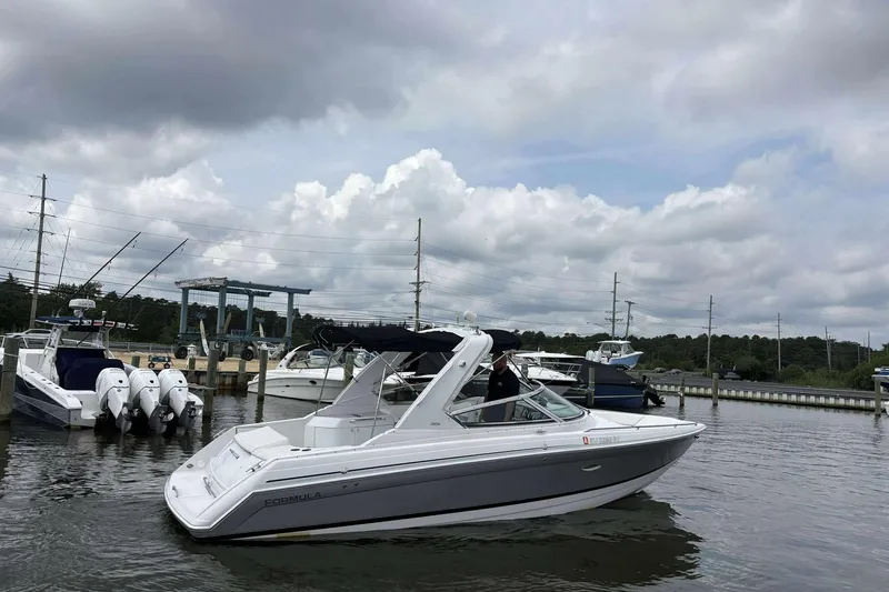Slide: The Image of 2004 Formula 2800 BR boat docked at marina under cloudy sky. - 3