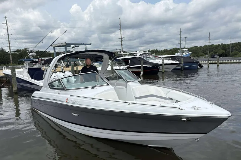 Slide: The Image of 2004 Formula 2800 BR boat docked in a marina with cloudy skies. - 4