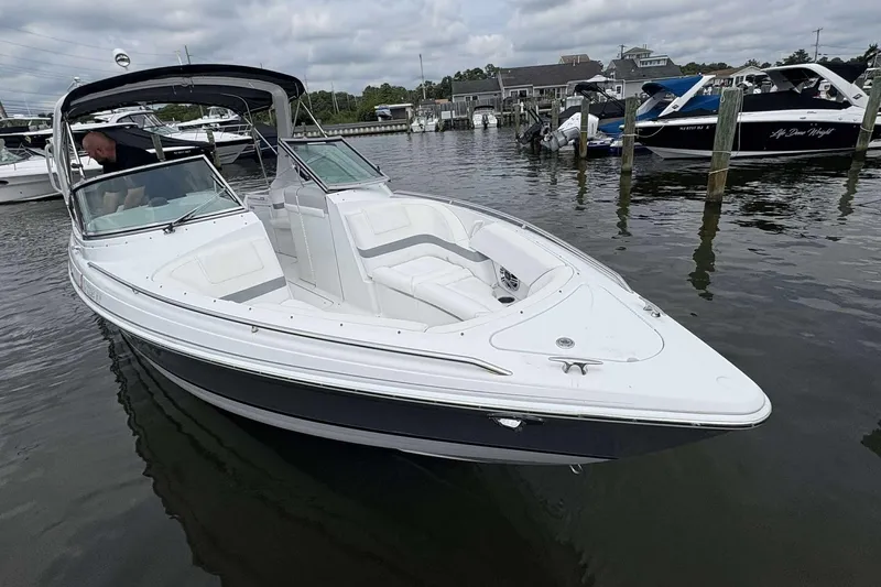 Slide: The Image of 2004 Formula 2800 BR boat docked in a marina, featuring sleek white design. - 6