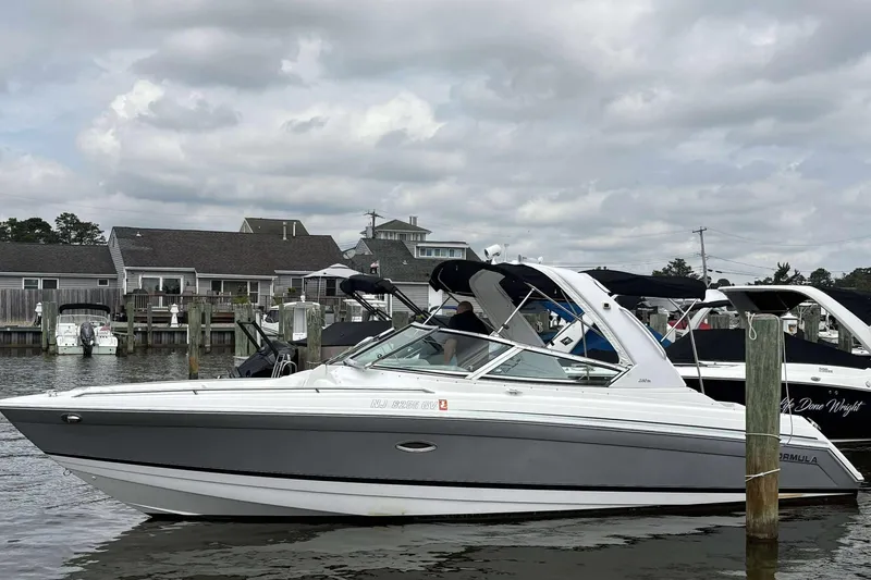 Slide: The Image of 2004 Formula 2800 BR boat docked at marina under cloudy sky. - 8