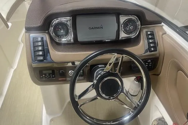 Slide: The Image of 2014 Chaparral 257 SSX boat dashboard with Garmin navigation system and steering wheel. - 10