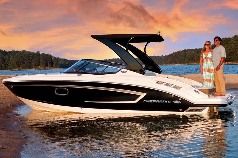 Slide: The Image of Manufacturer Provided Image: 2014 Chaparral 257 SSX boat on water at sunset with two people. - 14