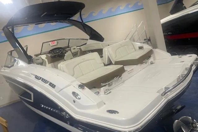 Slide: The Image of 2014 Chaparral 257 SSX boat with spacious seating and sleek design in showroom. - 5