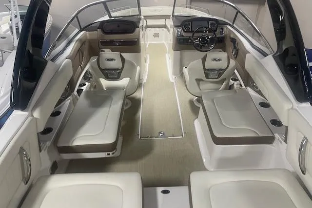 Slide: The Image of 2014 Chaparral 257 SSX boat interior with spacious seating and modern dashboard. - 6