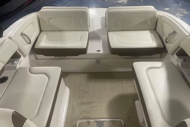 Slide: The Image of 2014 Chaparral 257 SSX boat interior with white cushioned seating arrangement. - 7