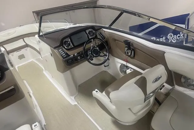 Slide: The Image of 2014 Chaparral 257 SSX boat interior with steering wheel and dashboard controls. - 9