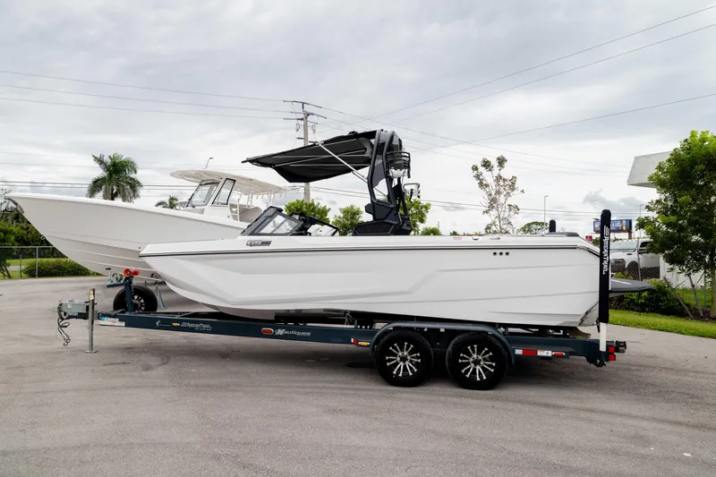 The Image of 2026 Nautique Super Air Nautique GS22 boat on trailer, parked outdoors. - 0