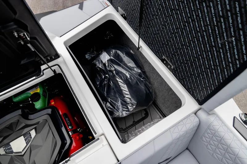 Slide: The Image of 2026 Nautique Super Air Nautique GS22 storage compartment with engine and equipment. - 18