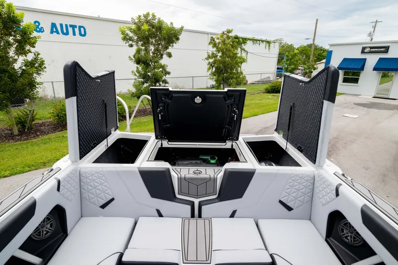 Slide: The Image of 2026 Nautique Super Air Nautique GS22 boat interior with open storage compartments. - 21